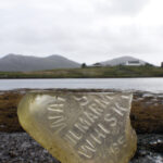 A piece of on old whisky bottle on the beach in lochmaddy
